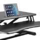 Sit Stand Desk Riser in black, lowered with tablet