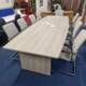 Grey wood boardroom table for 10 with optional pop up units, end view