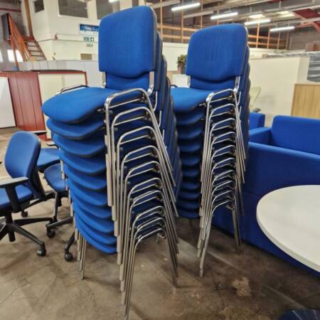 used stacking chairs in blue fabric and chrome legs